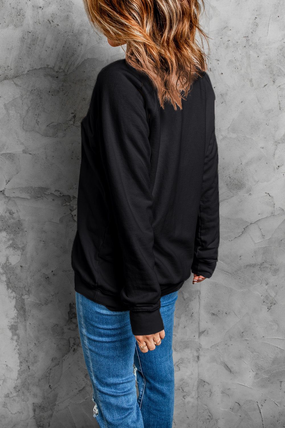 Black long sleeve sweatshirt featuring a heart print with the word 'THANKFUL' in stylish typography.