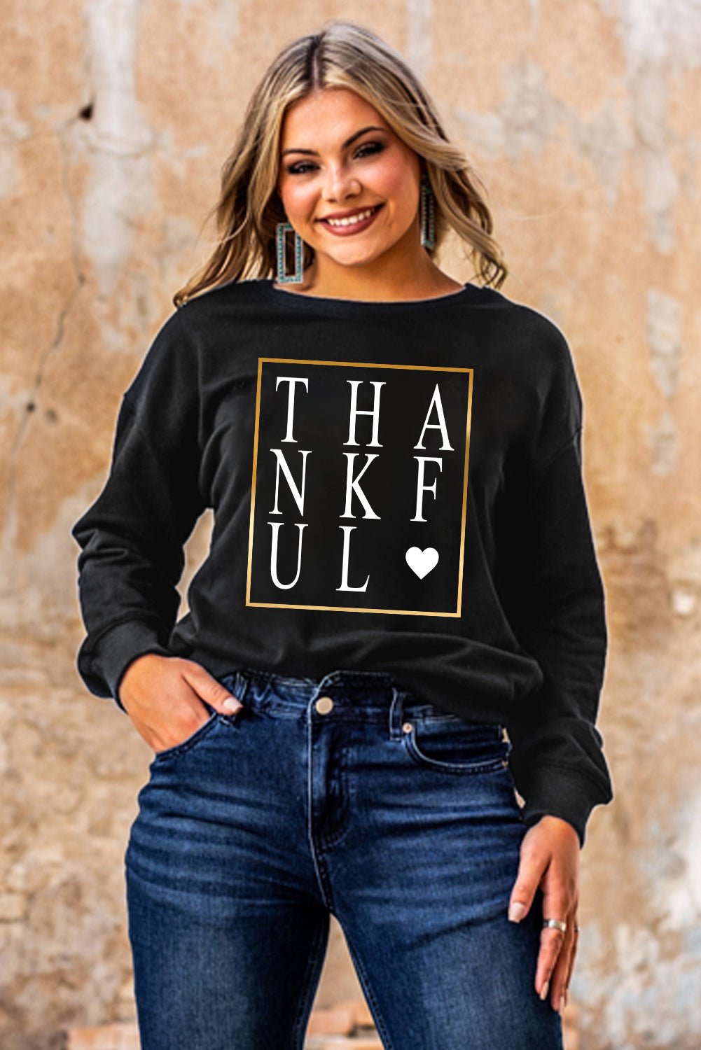 Black long sleeve sweatshirt featuring a heart print with the word 'THANKFUL' in stylish typography.