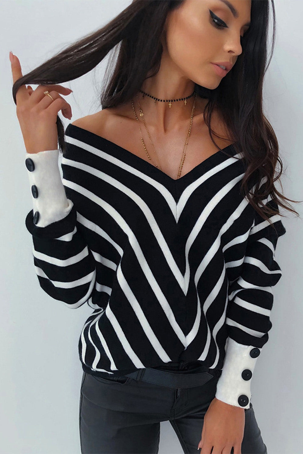 Black V Neck Popper Cuff Striped Casual Sweater featuring a deep V neck and elastic cuffs, styled with a classic chevron striped pattern.