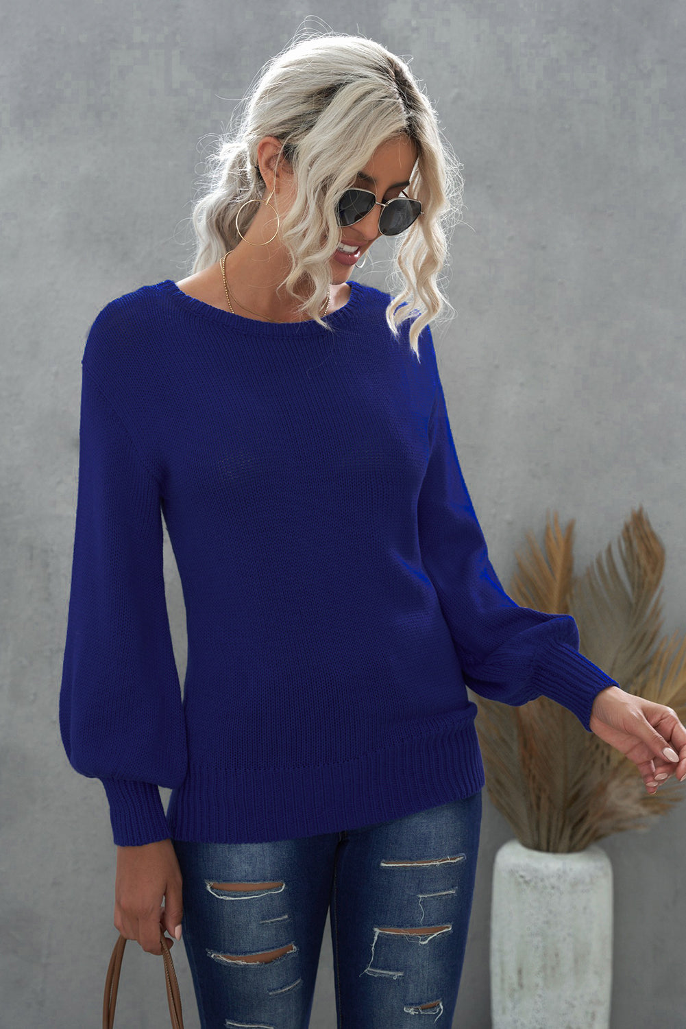 Blue drop shoulder sweater featuring a back cut-out and tie detail, showcasing a stylish and elegant design.