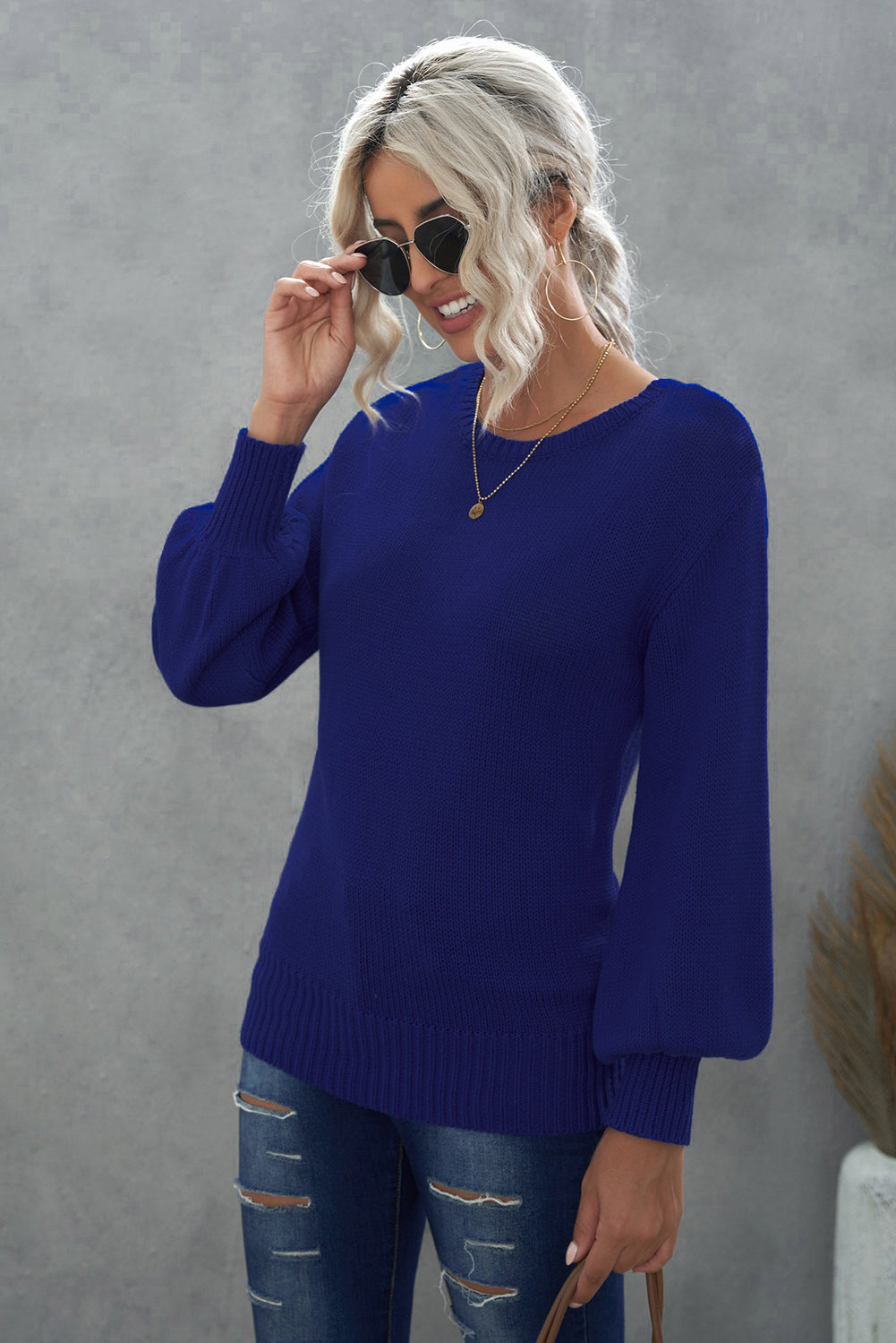 Blue drop shoulder sweater featuring a back cut-out and tie detail, showcasing a stylish and elegant design.