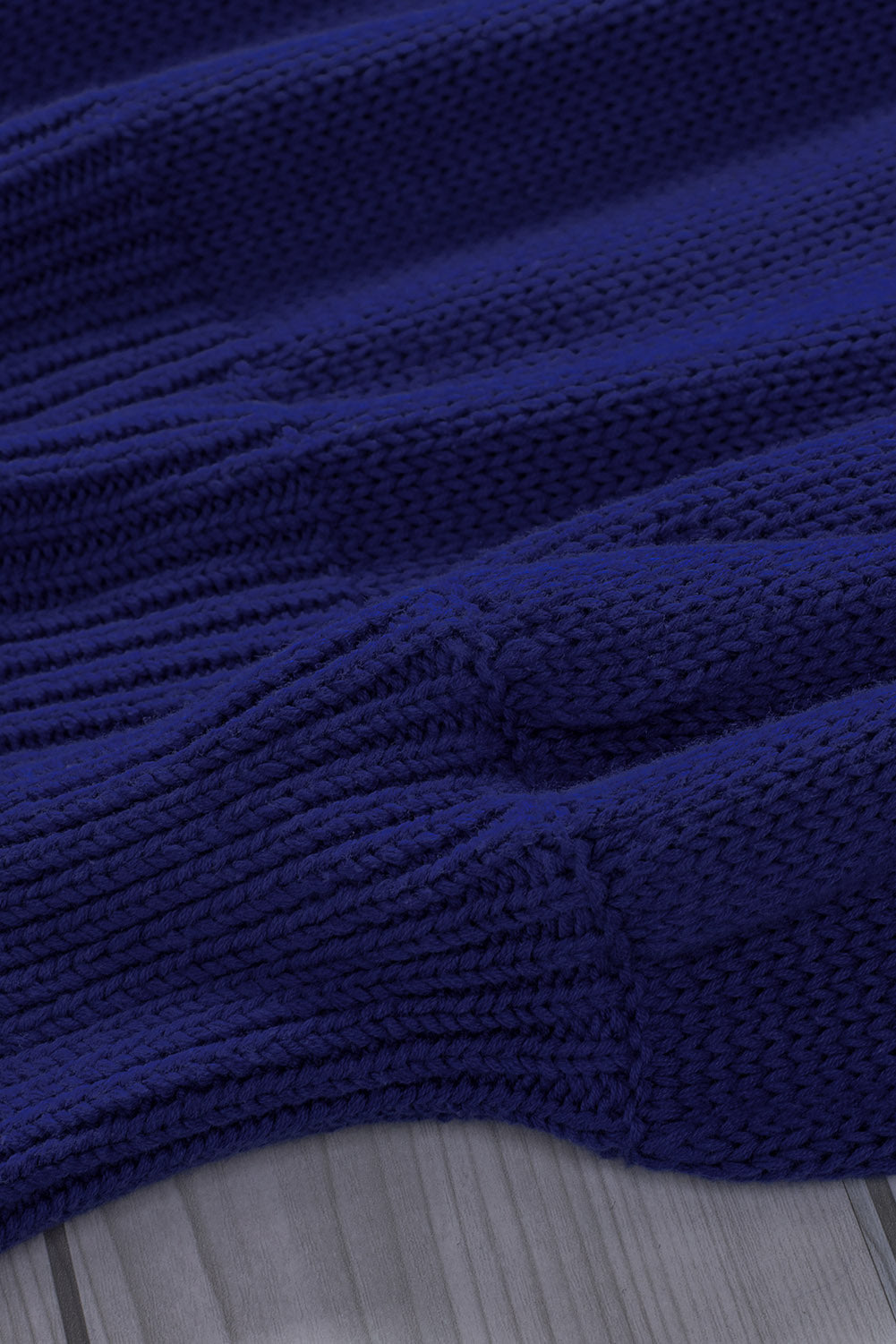 Blue drop shoulder sweater featuring a back cut-out and tie detail, showcasing a stylish and elegant design.