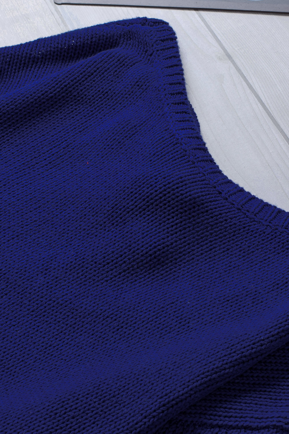 Blue drop shoulder sweater featuring a back cut-out and tie detail, showcasing a stylish and elegant design.