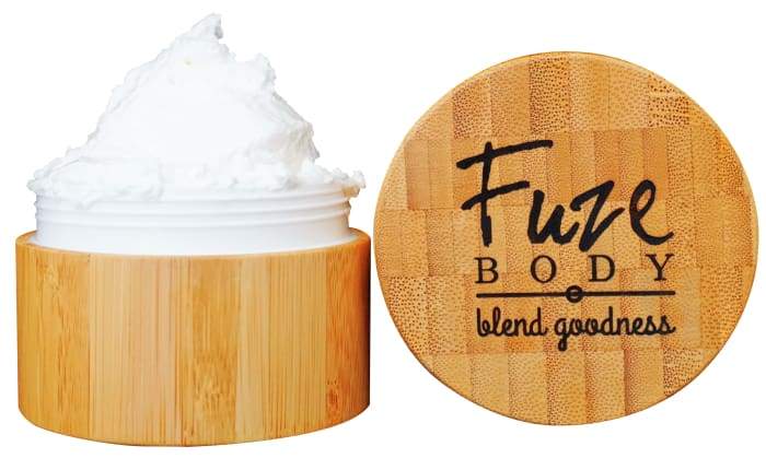 A jar of Body Butter - Muscle Recovery with a light and fluffy texture, surrounded by natural ingredients like shea butter and essential oils.
