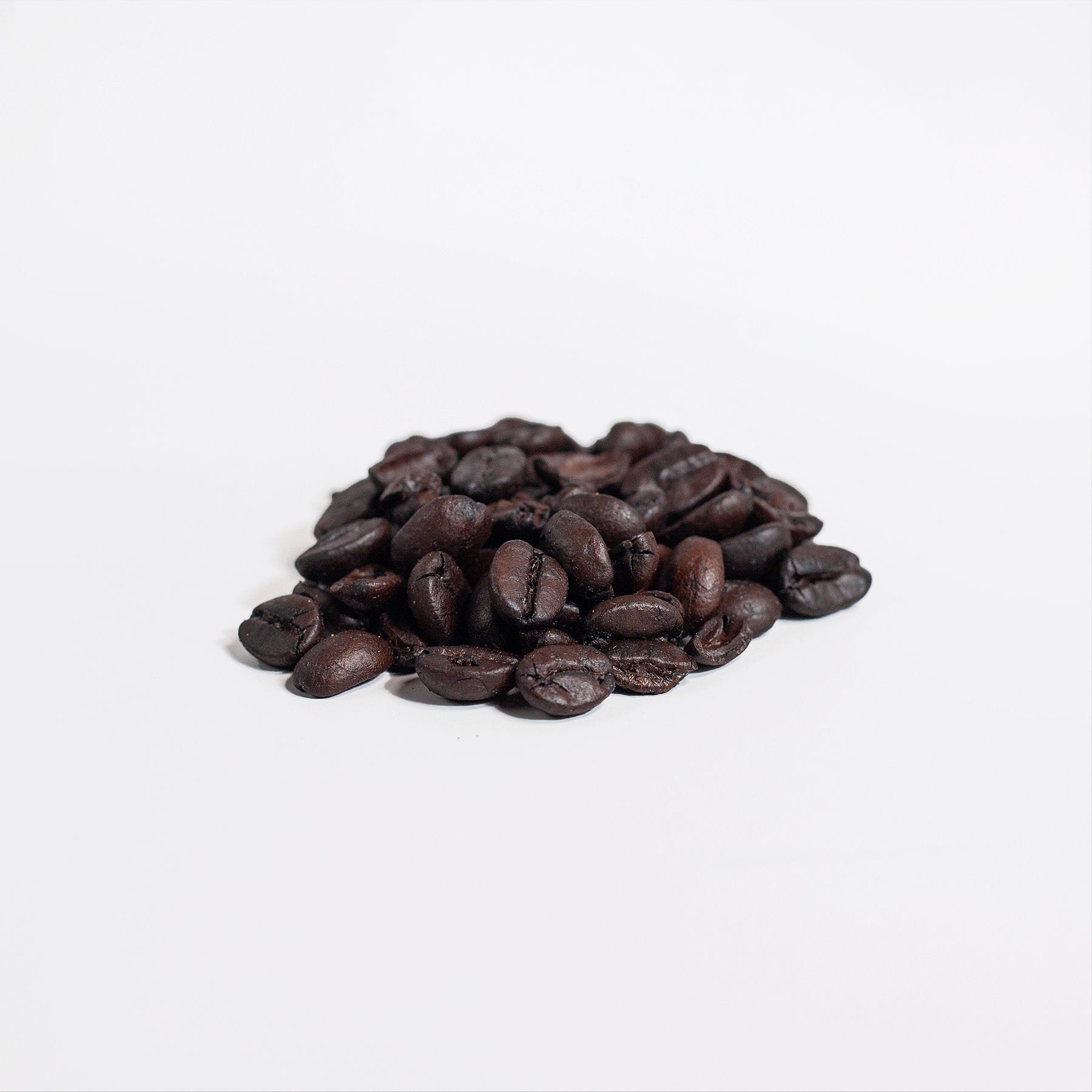 A 4oz package of Brazilian Blend coffee featuring whole Arabica beans with rich cocoa, caramel, and walnut notes.