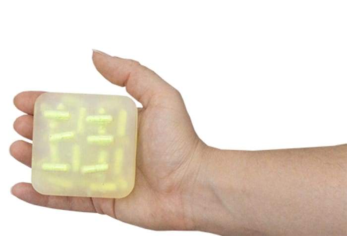 Breathe Clear Burst Bar with wooden soap dish, showcasing its vibrant colors and unique design.