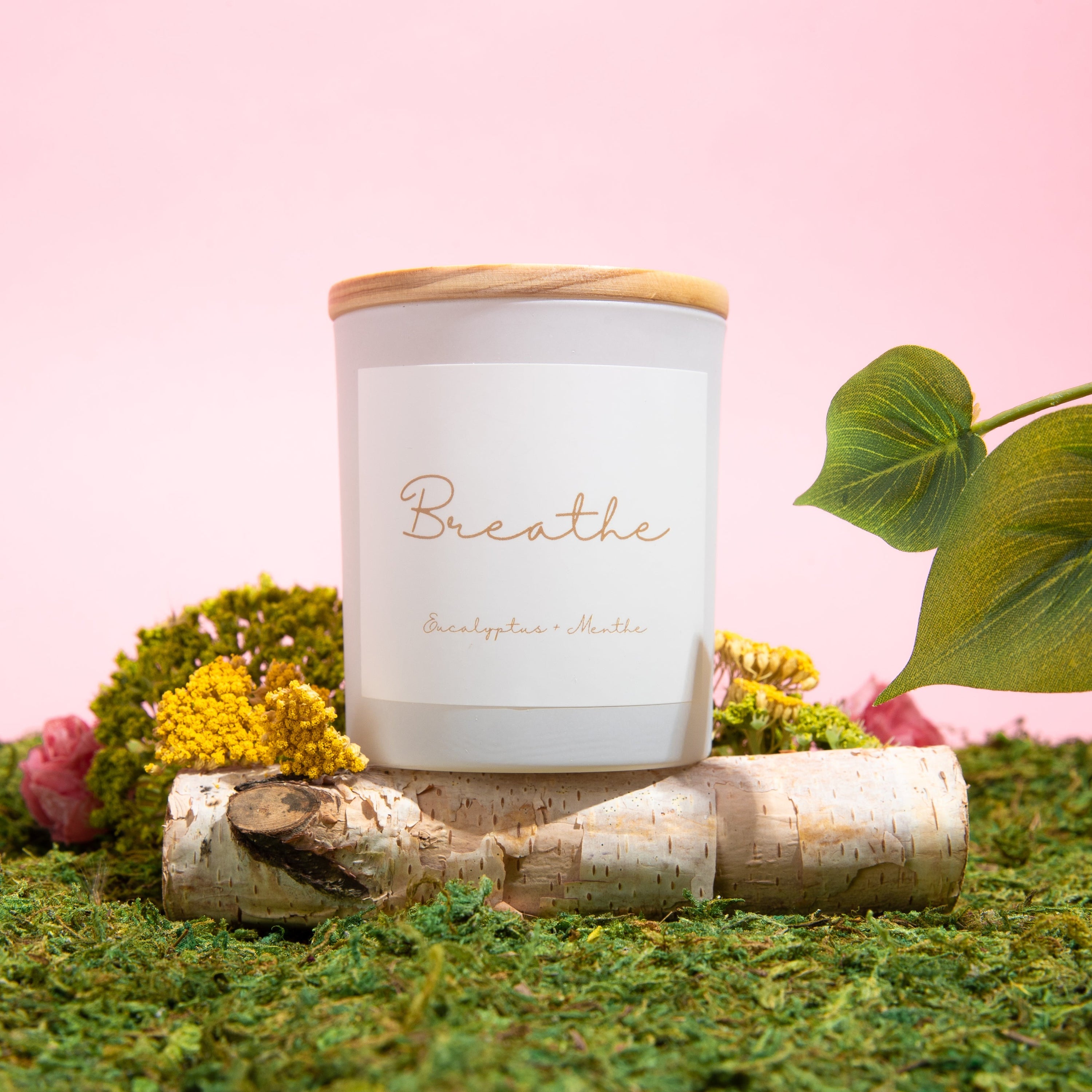 BREATHE candle in a glass jar with wooden lid, featuring eucalyptus and mint scent, showcasing a clean and elegant design.