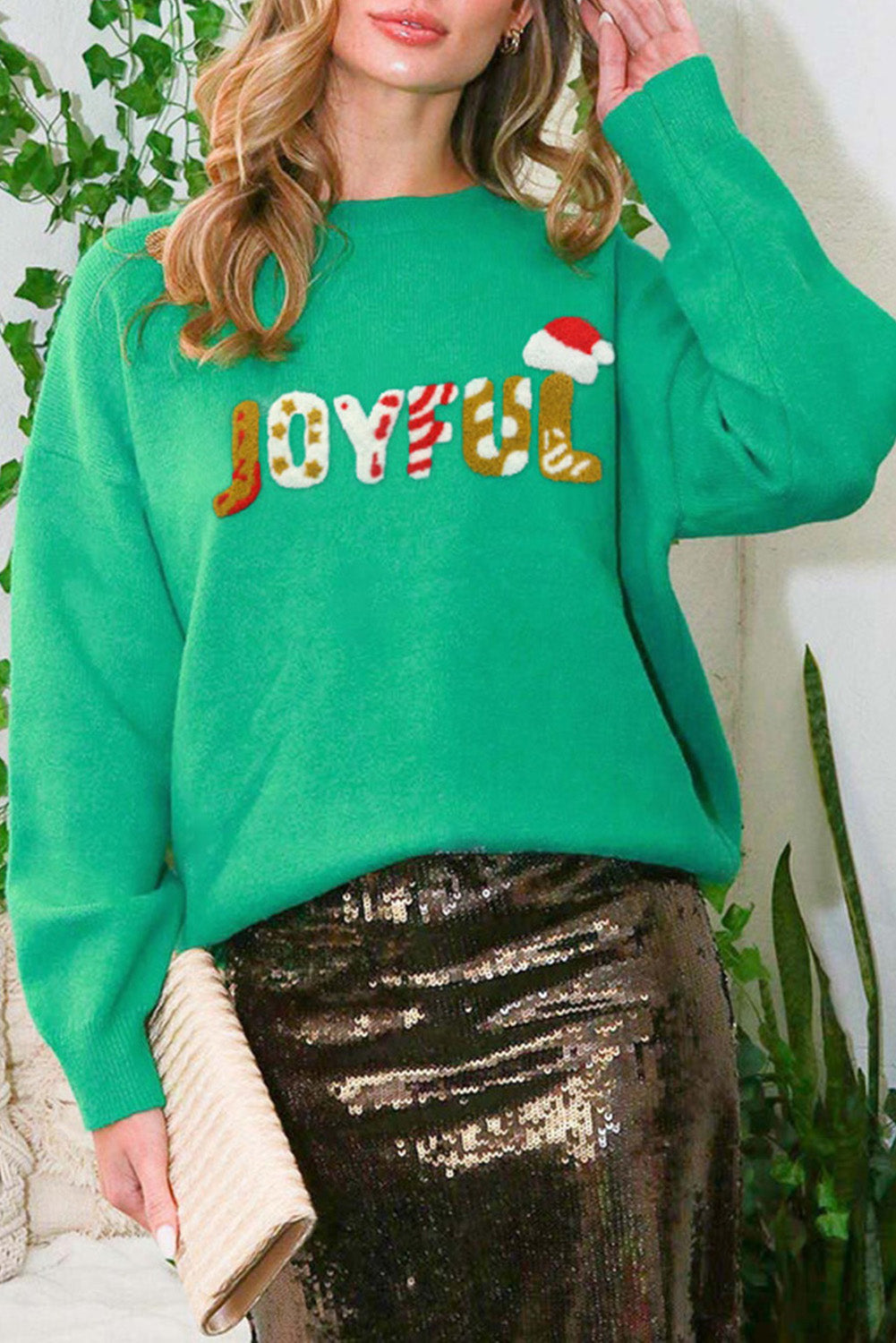 Bright green Christmas sweater featuring sequined JOYFUL graphic, perfect for festive occasions.