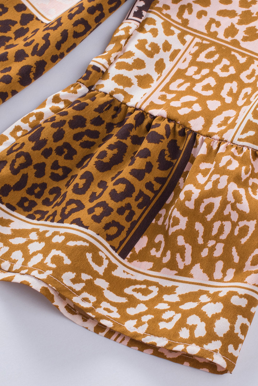 Brown Colorblock Leopard Ribbon Tie Blouse featuring a V-neck and long sleeves, designed for a relaxed fit.