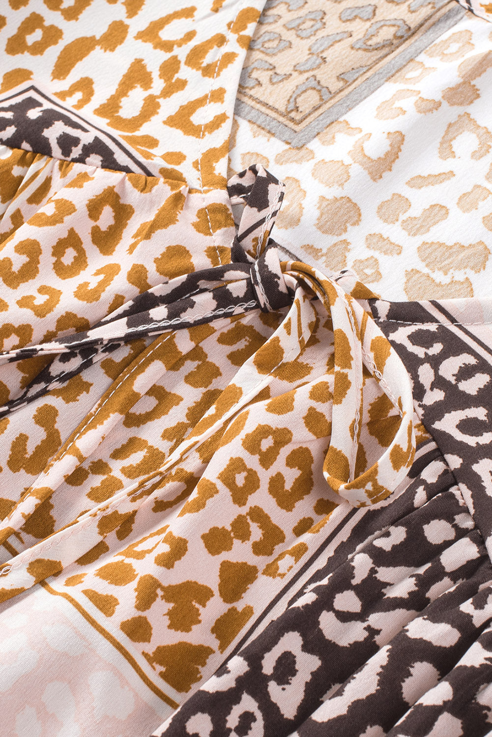 Brown Colorblock Leopard Ribbon Tie Blouse featuring a V-neck and long sleeves, designed for a relaxed fit.