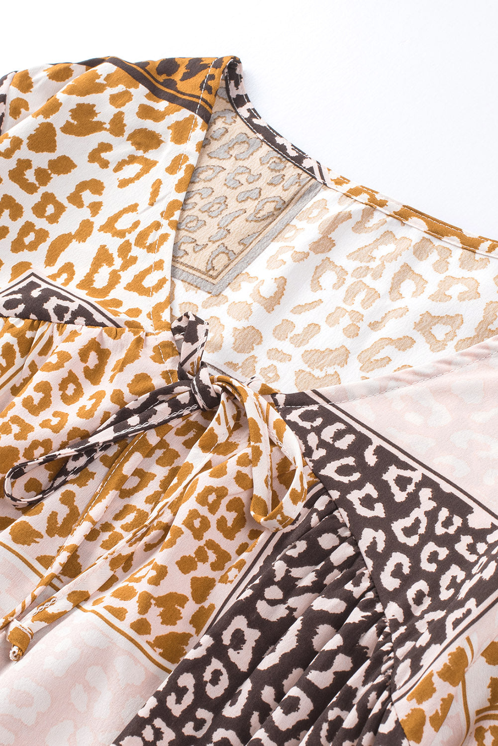 Brown Colorblock Leopard Ribbon Tie Blouse featuring a V-neck and long sleeves, designed for a relaxed fit.