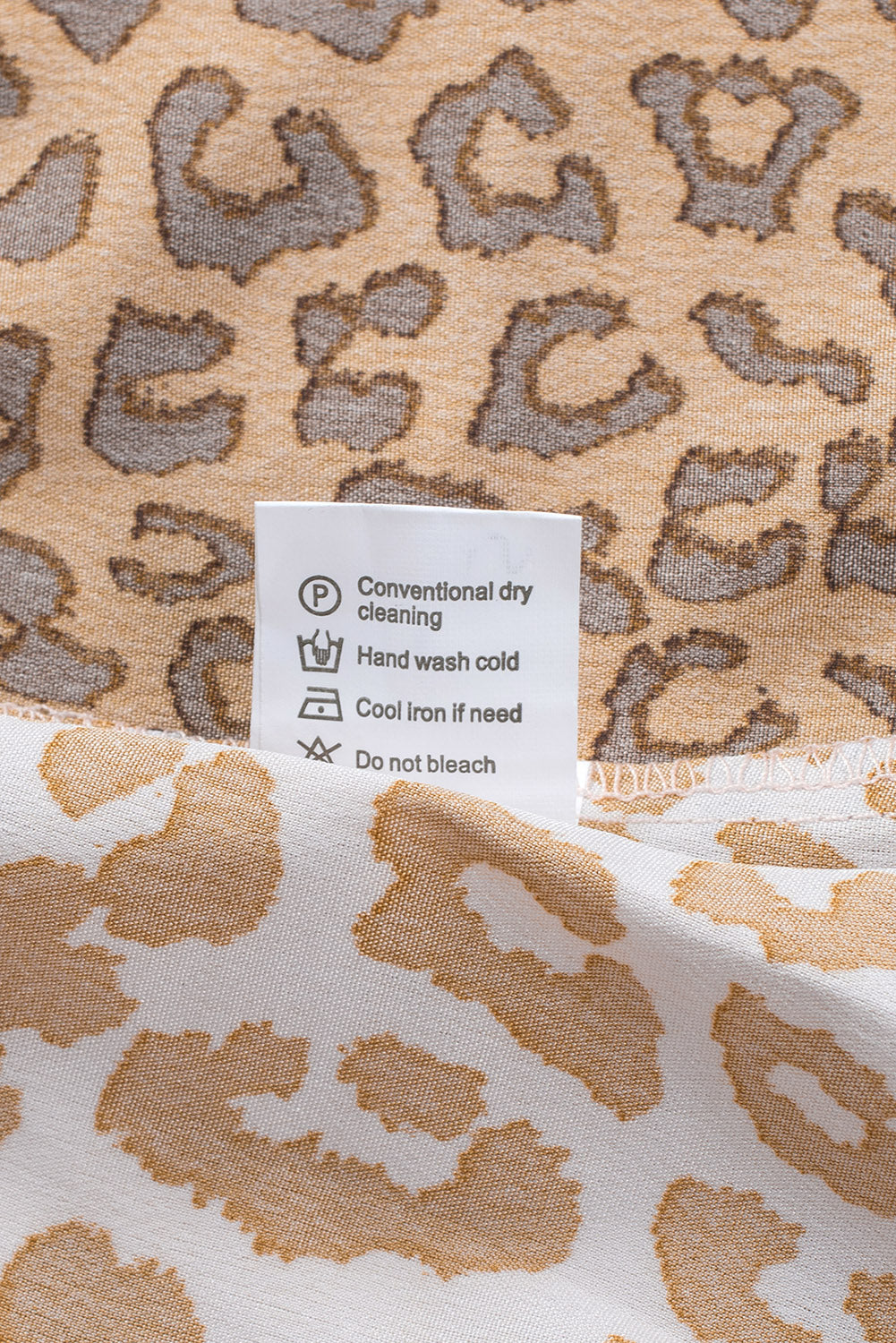 Brown Colorblock Leopard Ribbon Tie Blouse featuring a V-neck and long sleeves, designed for a relaxed fit.