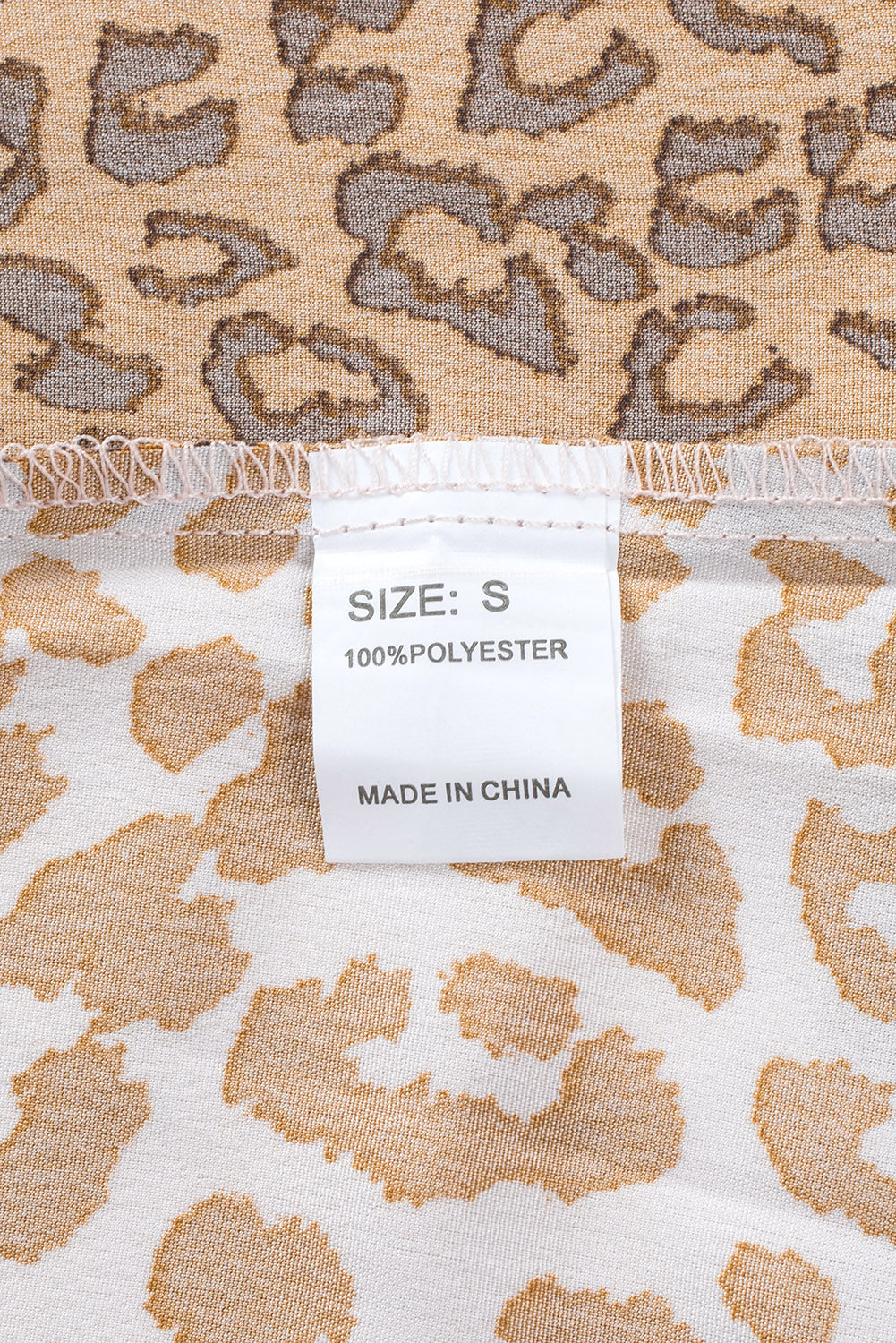 Brown Colorblock Leopard Ribbon Tie Blouse featuring a V-neck and long sleeves, designed for a relaxed fit.