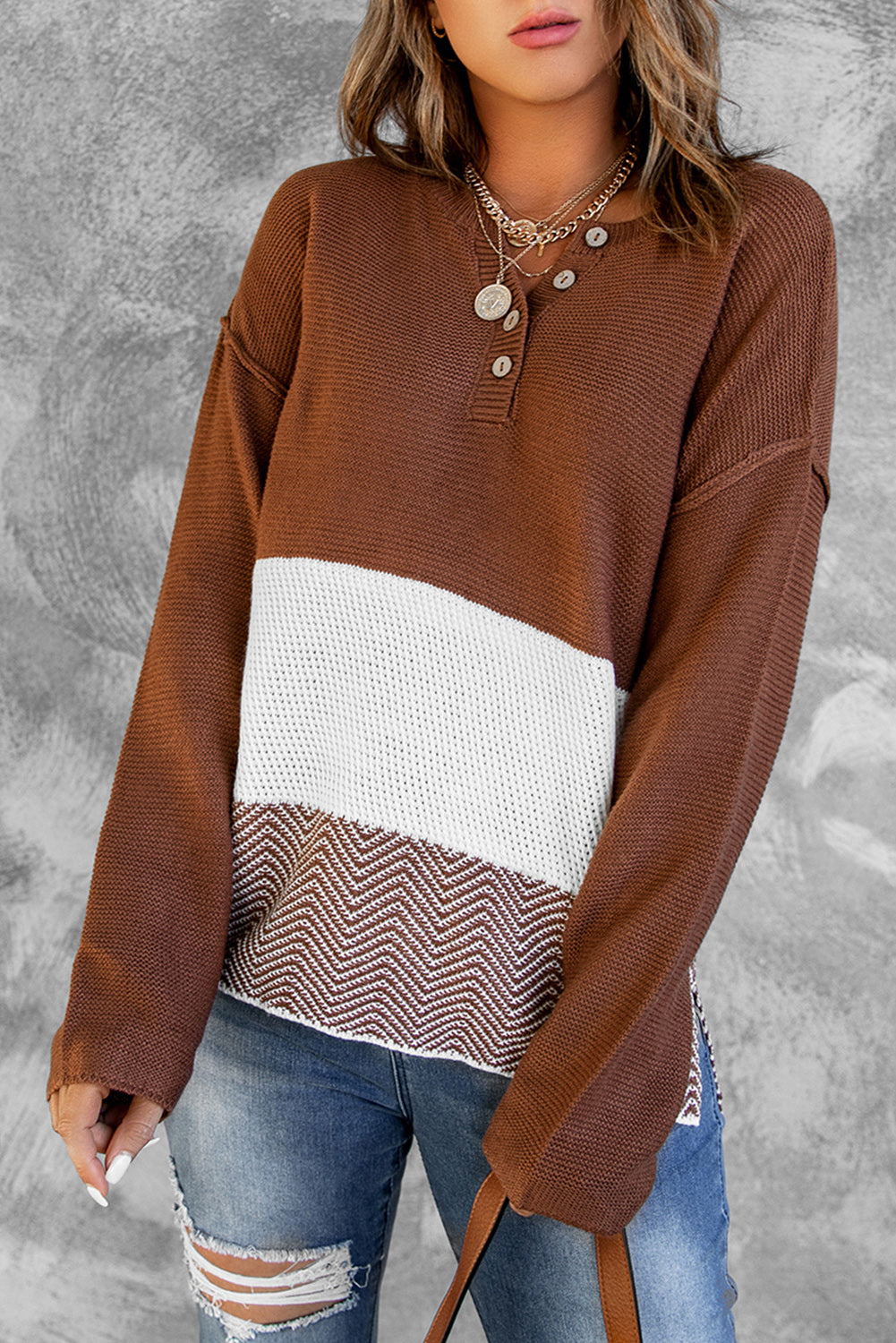 A stylish brown knitted long sleeve sweater featuring color splicing and buttoned design, perfect for casual outfits.