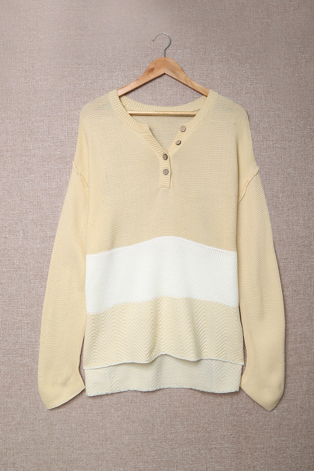 A stylish brown knitted long sleeve sweater featuring color splicing and buttoned design, perfect for casual outfits.