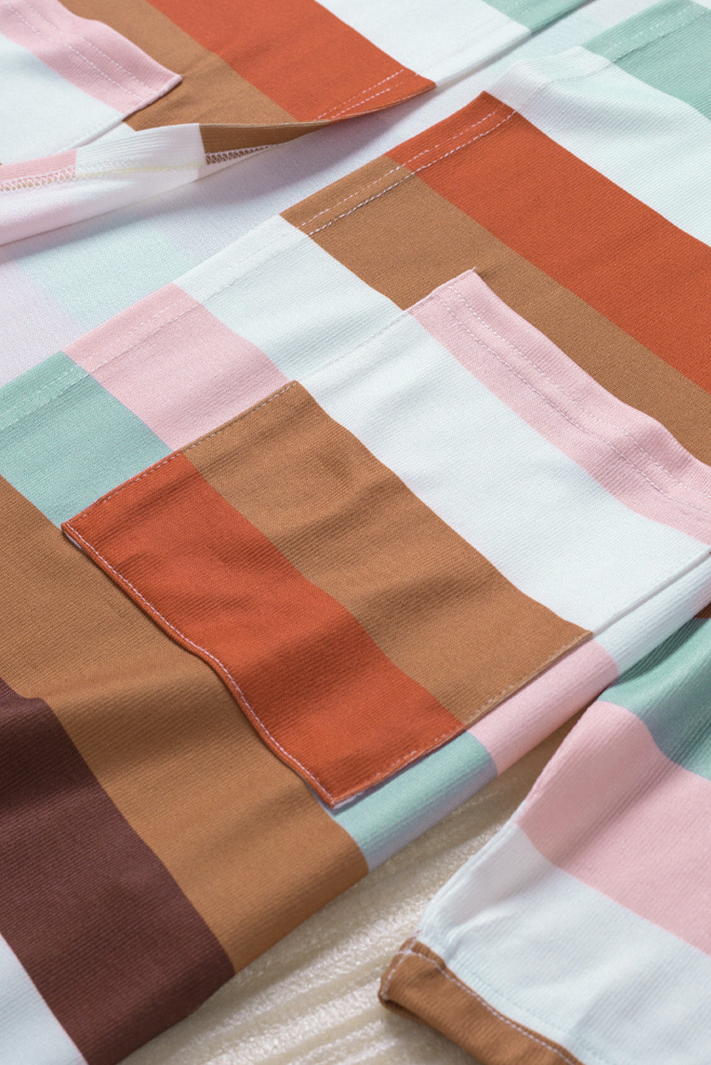 Brown stripe print open front plus size cardigan with pockets, showcasing a stylish design and lightweight knit fabric.