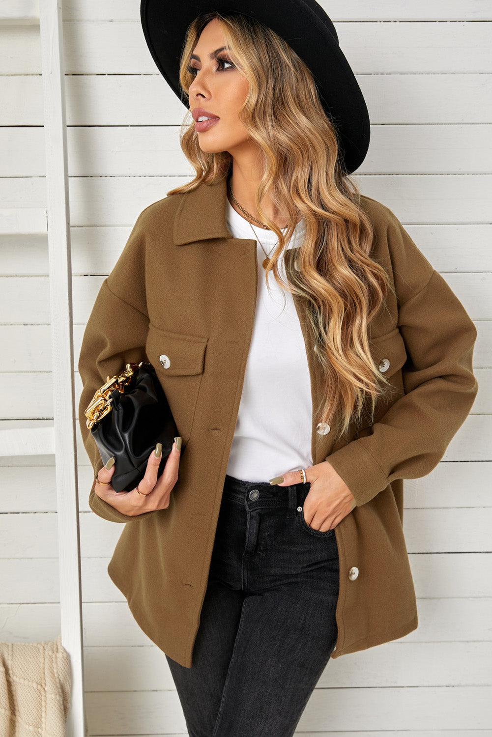 A stylish brown coat featuring a turn down collar, buttoned closure, and flap pockets, designed for a baggy fit.