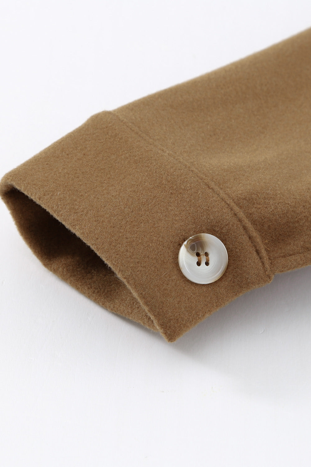 A stylish brown coat featuring a turn down collar, buttoned closure, and flap pockets, designed for a baggy fit.