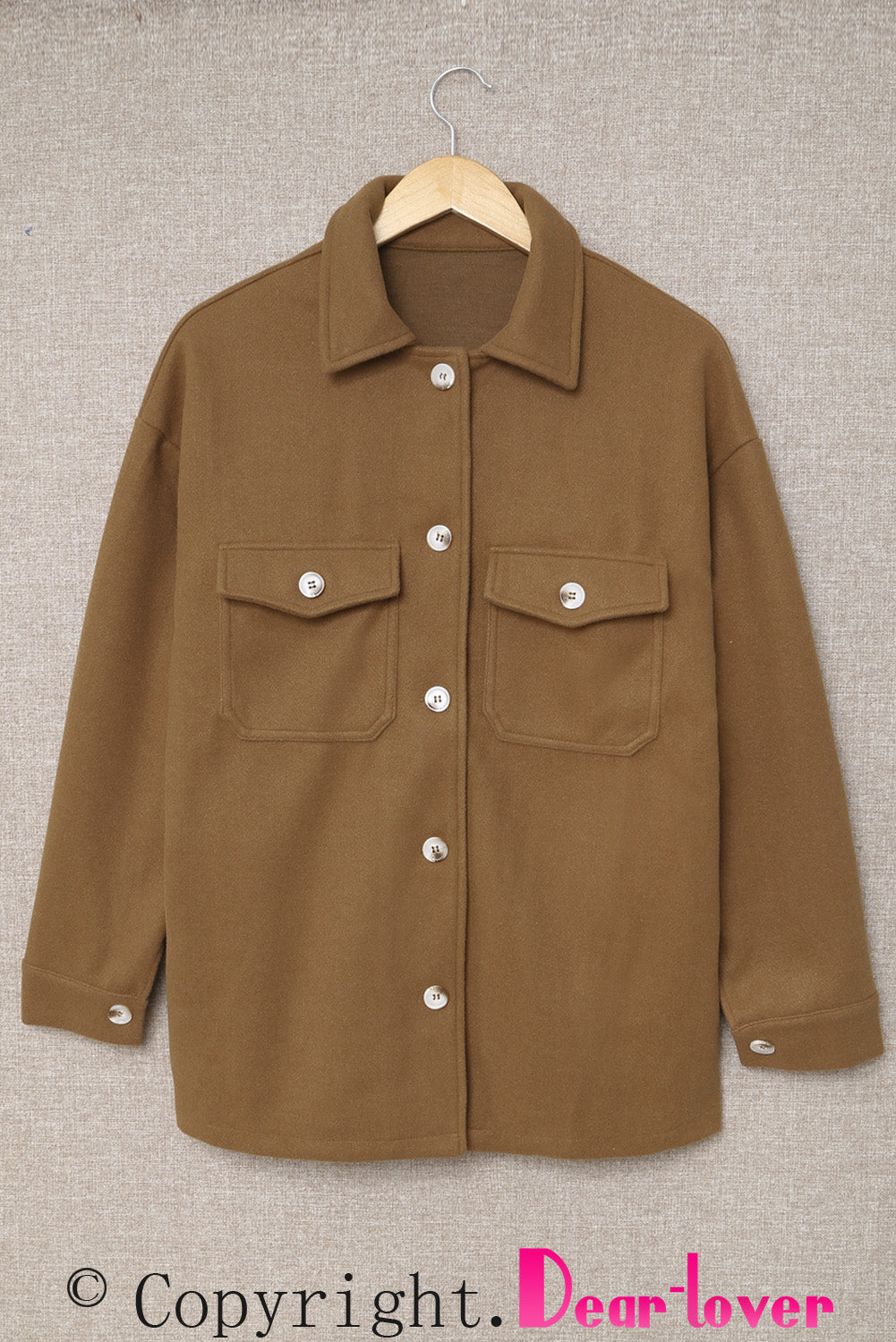 A stylish brown coat featuring a turn down collar, buttoned closure, and flap pockets, designed for a baggy fit.