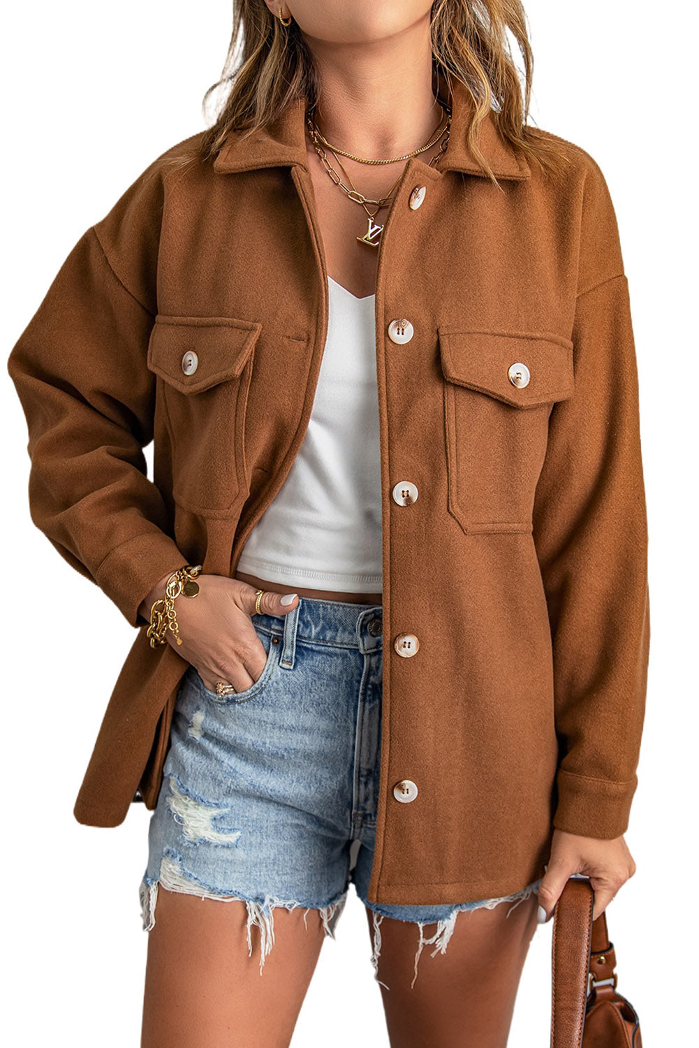 A stylish brown coat featuring a turn down collar, buttoned closure, and flap pockets, designed for a baggy fit.