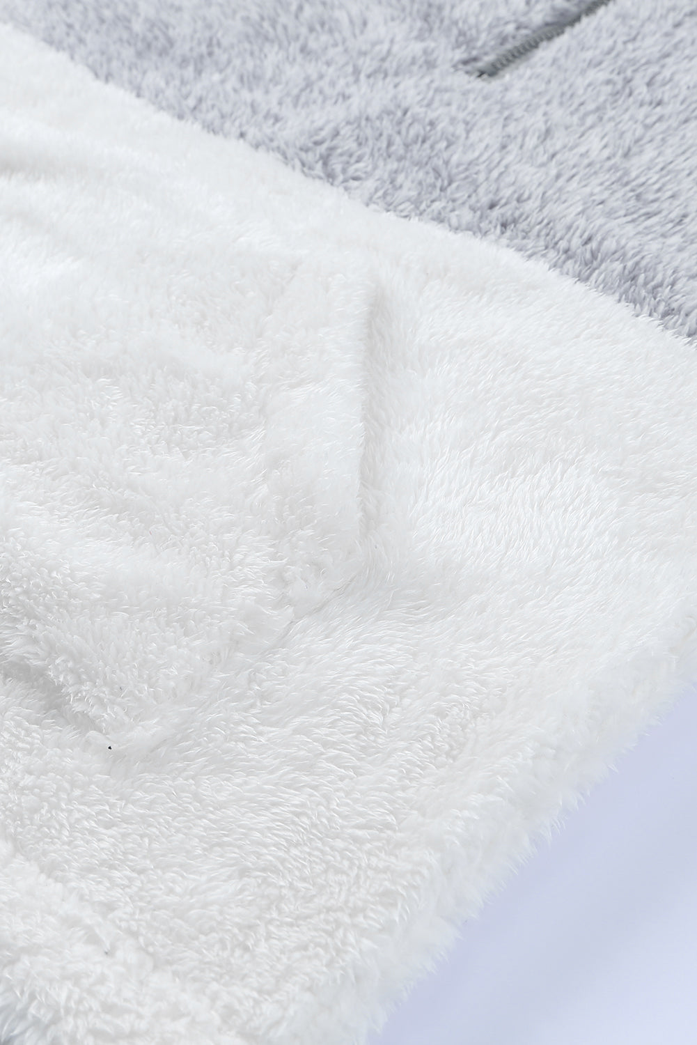 Brown oversized fleece pullover with zip neck and kangaroo pocket, perfect for winter wear.