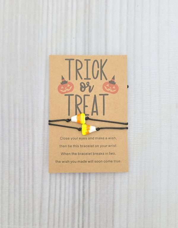 Colorful candy corn bracelets with adjustable slide knots, perfect for Halloween celebrations.