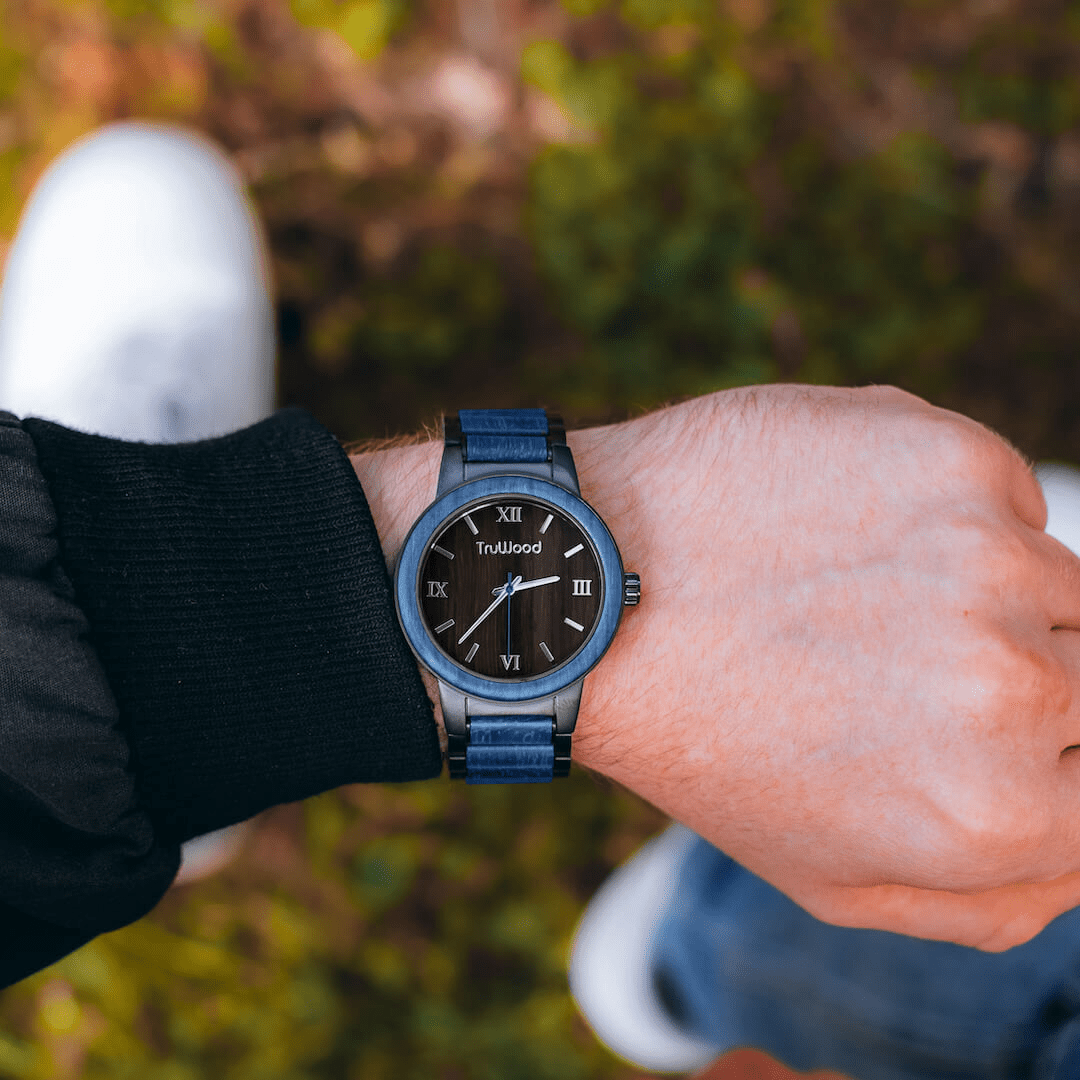 Coast Men's Watch featuring a stainless steel case, blue dyed maple wood bezel, and black sandalwood dial, showcasing its elegant design.