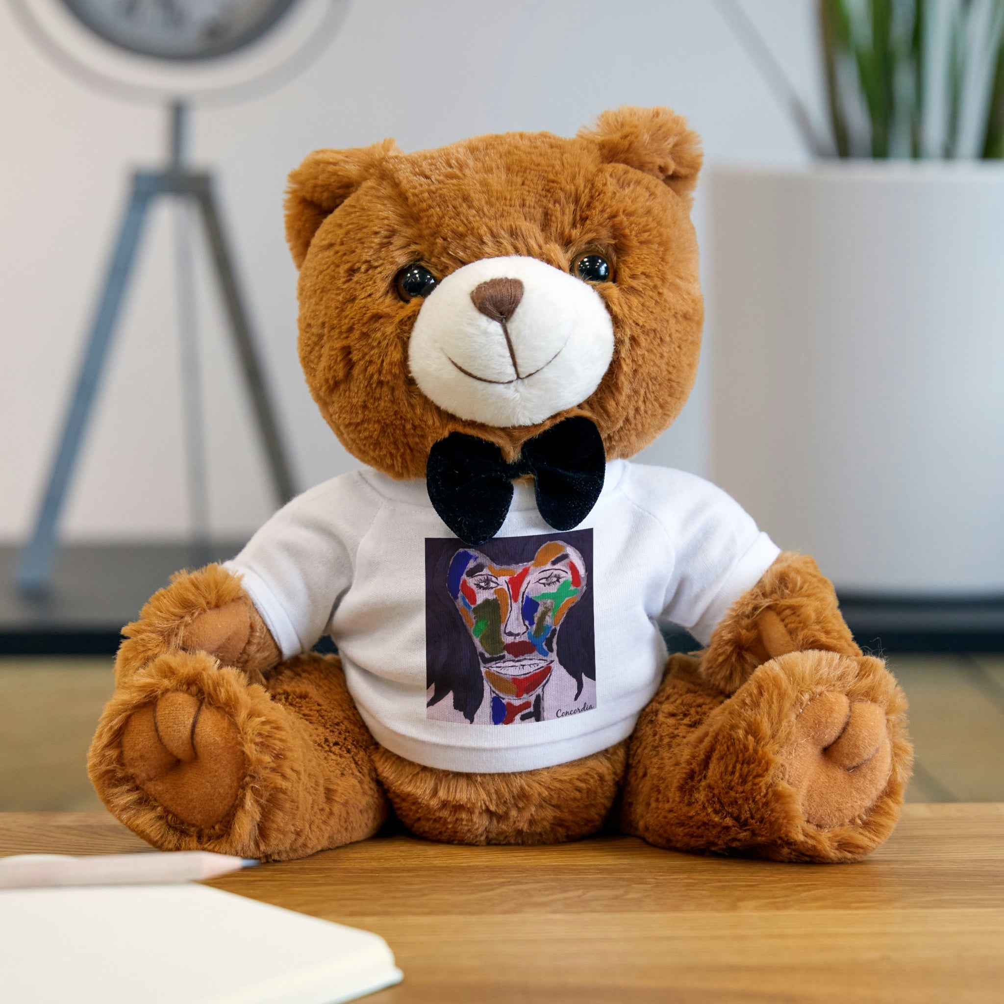 Concordia Teddy Bear with T-Shirt, featuring soft fur, a black bow tie, and a customizable t-shirt for personalization.