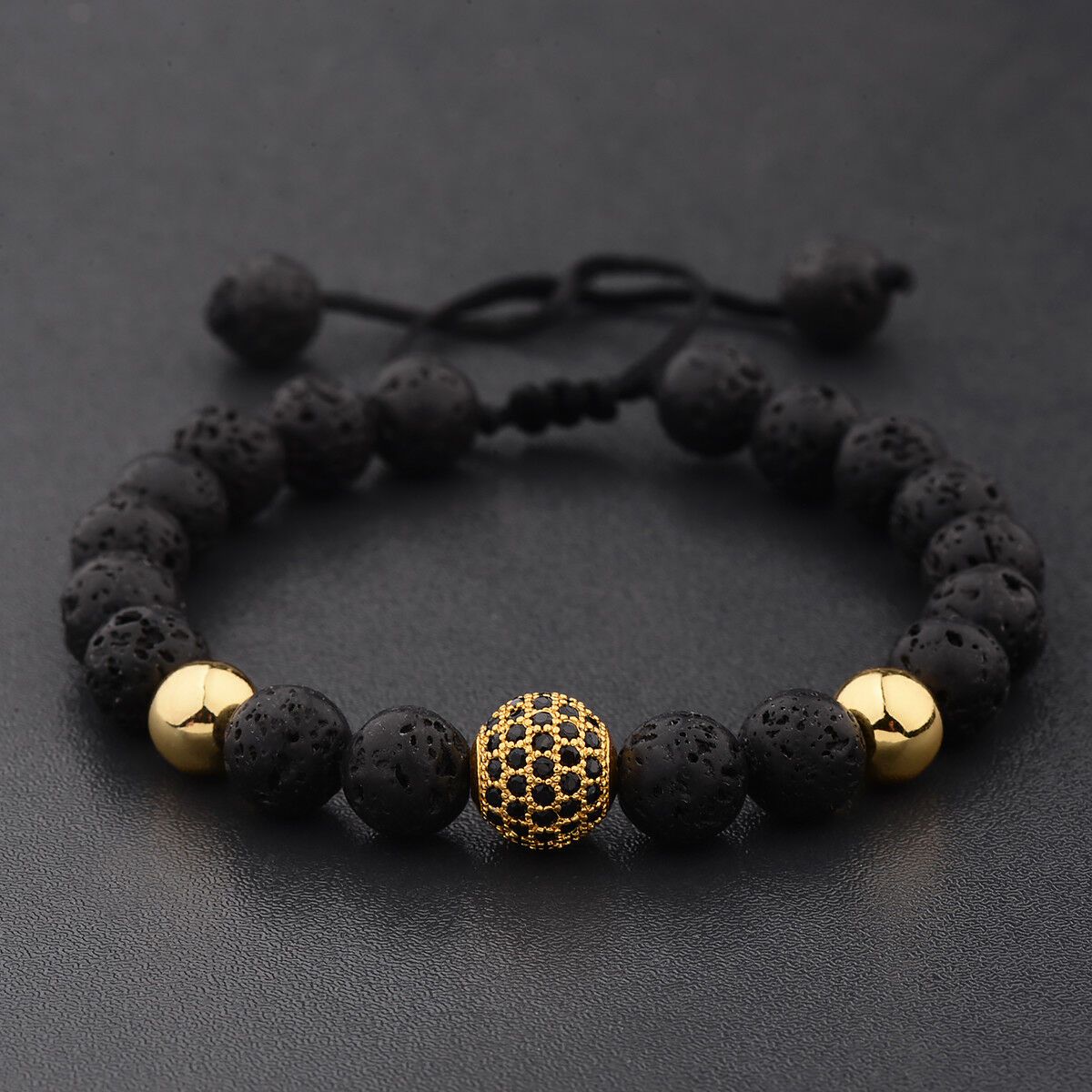 Crystal Ball Gold Lava Stone Bracelet featuring black lava stones and gold accents, perfect for essential oil diffusion.