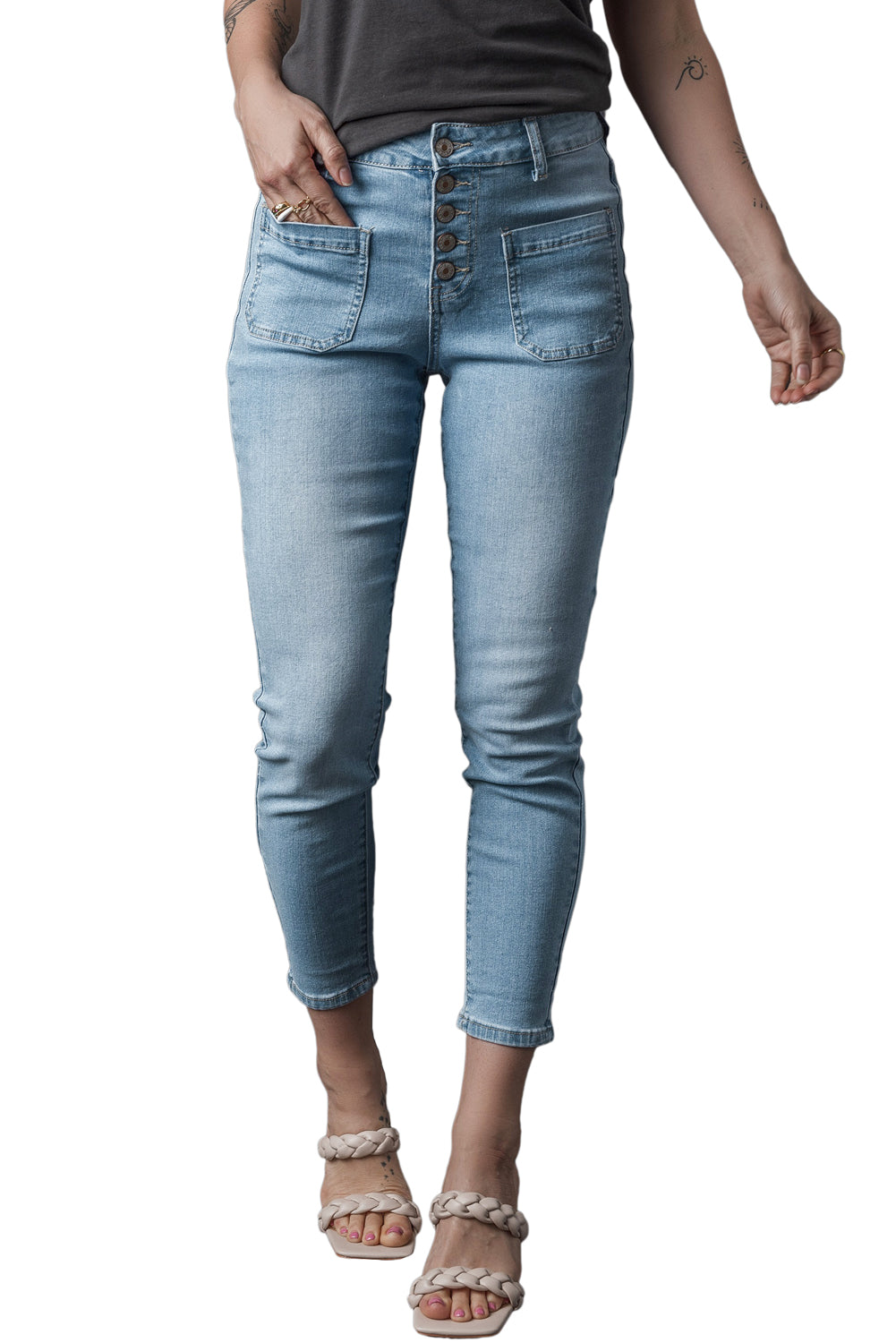 Dark blue skinny jeans featuring a button fly closure and pockets, designed for a stylish and comfortable fit.