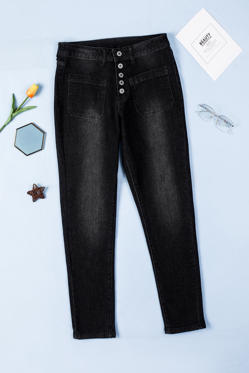 Dark blue skinny jeans featuring a button fly closure and pockets, designed for a stylish and comfortable fit.