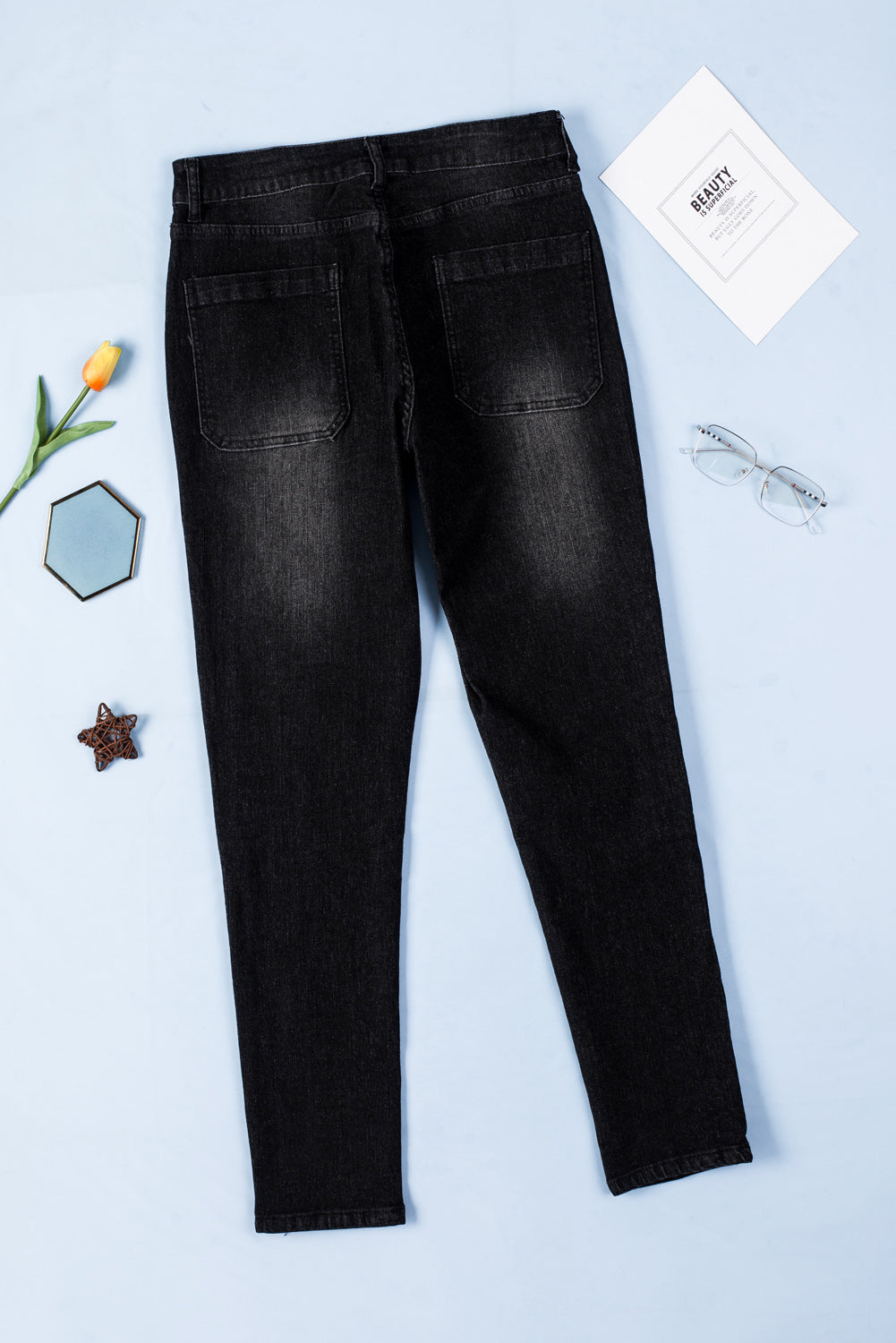 Dark blue skinny jeans featuring a button fly closure and pockets, designed for a stylish and comfortable fit.
