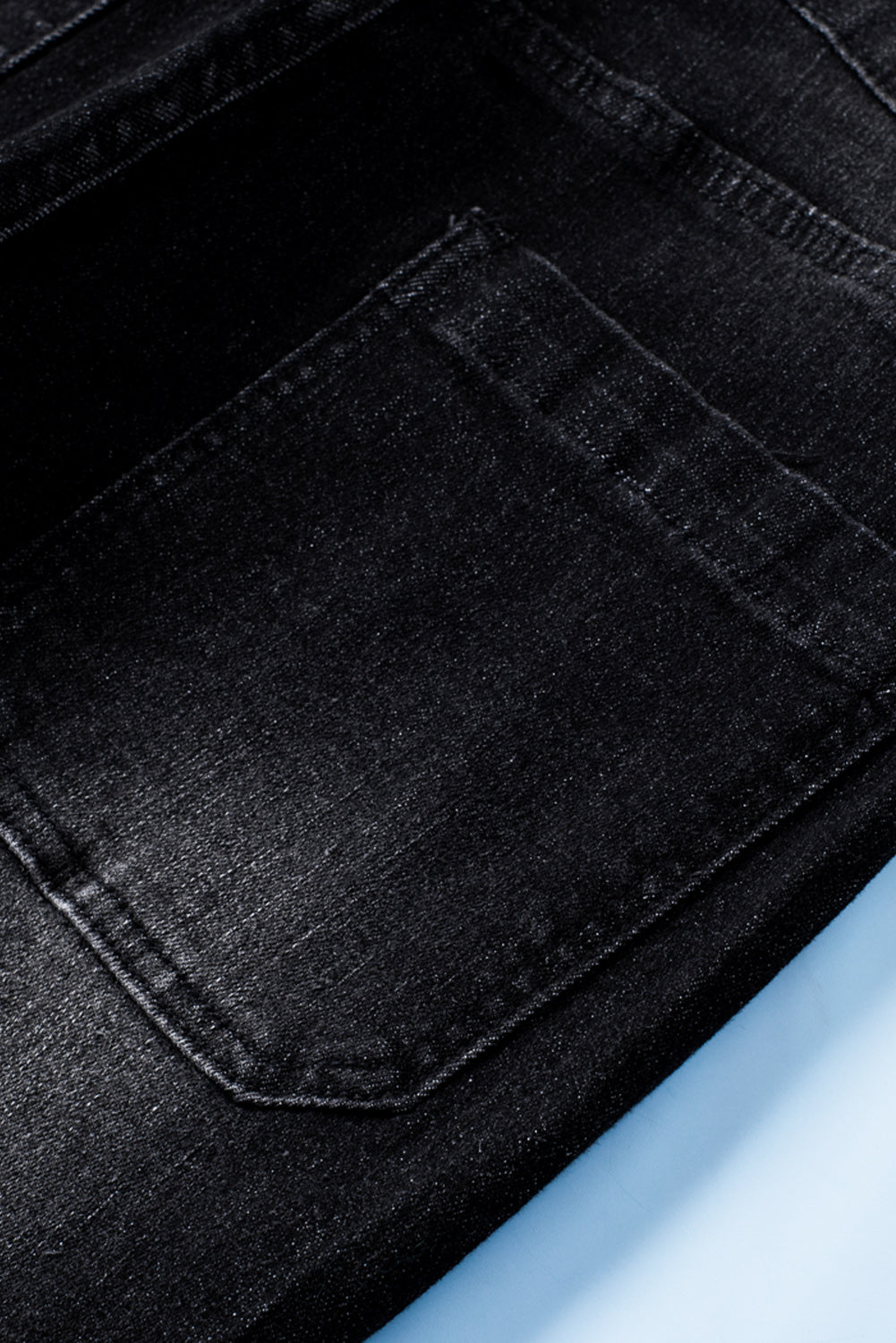 Dark blue skinny jeans featuring a button fly closure and pockets, designed for a stylish and comfortable fit.