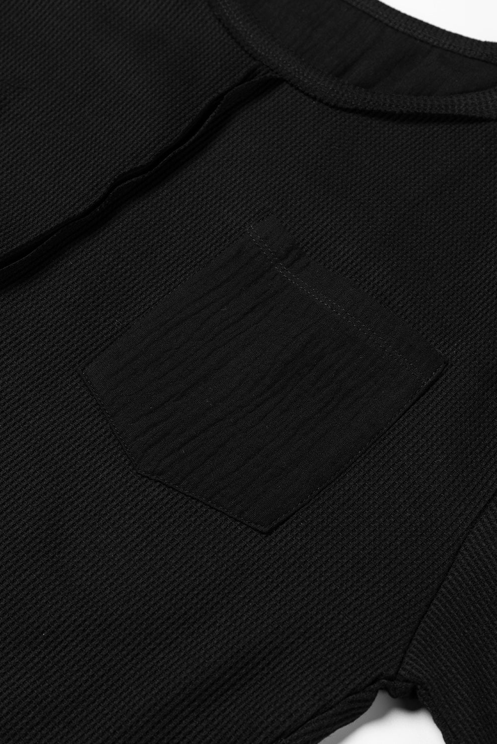 Dark brown waffle knit top with exposed seams and bubble sleeves, featuring a chic patchwork design and front pocket.