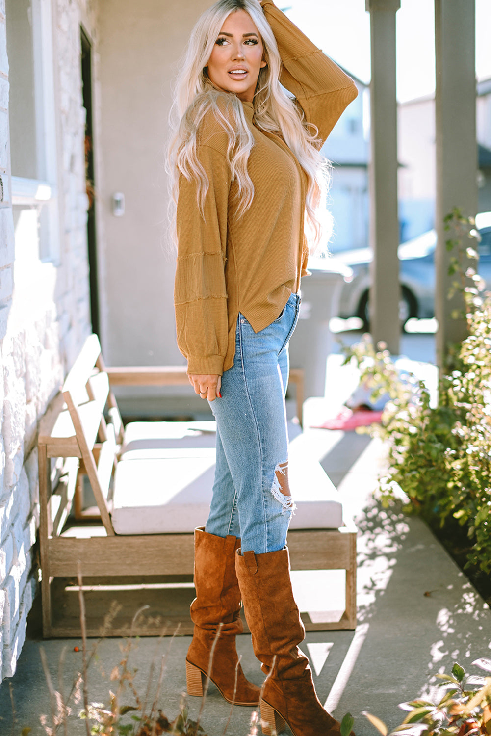 Dark brown waffle knit top with exposed seams and bubble sleeves, featuring a chic patchwork design and front pocket.