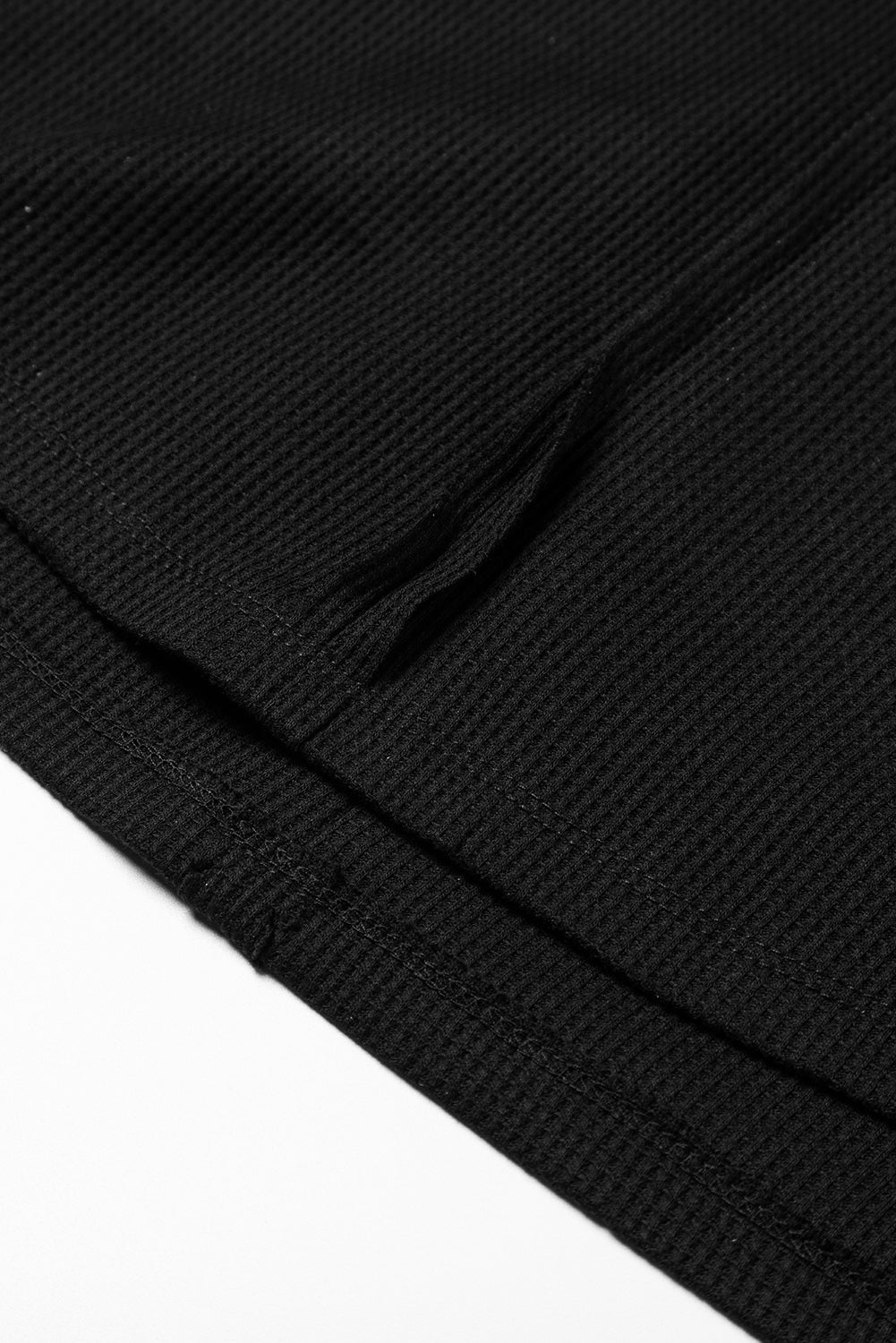 Dark brown waffle knit top with exposed seams and bubble sleeves, featuring a chic patchwork design and front pocket.