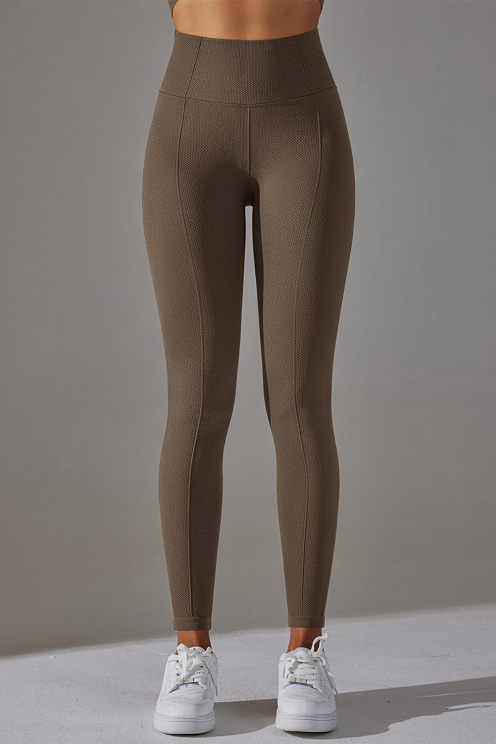 Dark grey high waist yoga leggings with stylish outer seam details, perfect for workouts and casual wear.