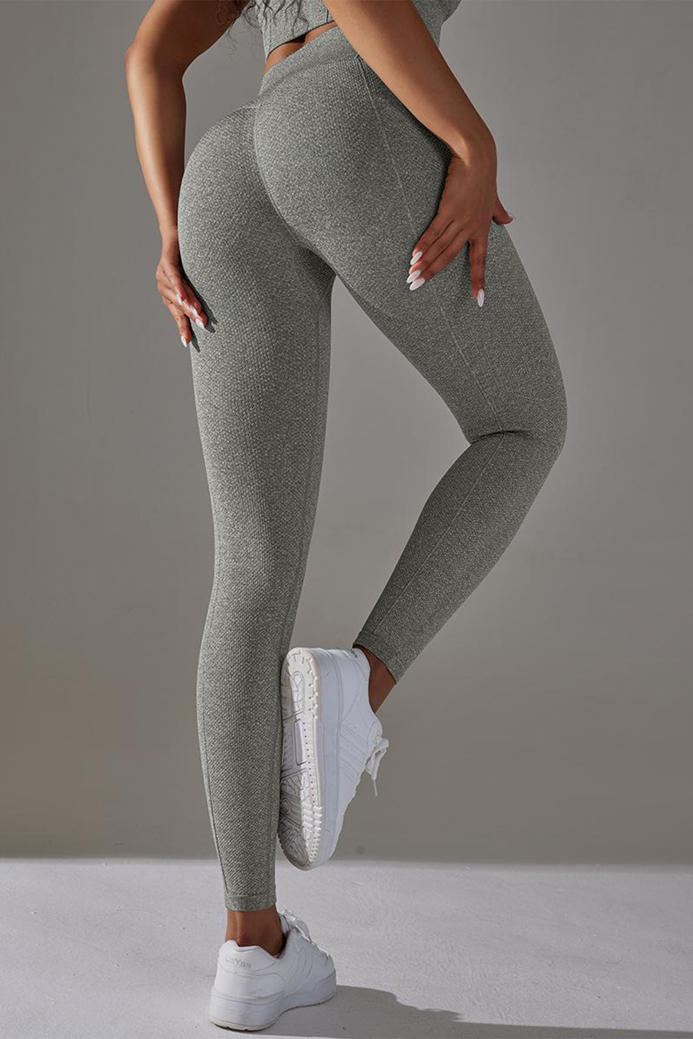 Dark grey high waist yoga leggings with stylish outer seam details, perfect for workouts and casual wear.