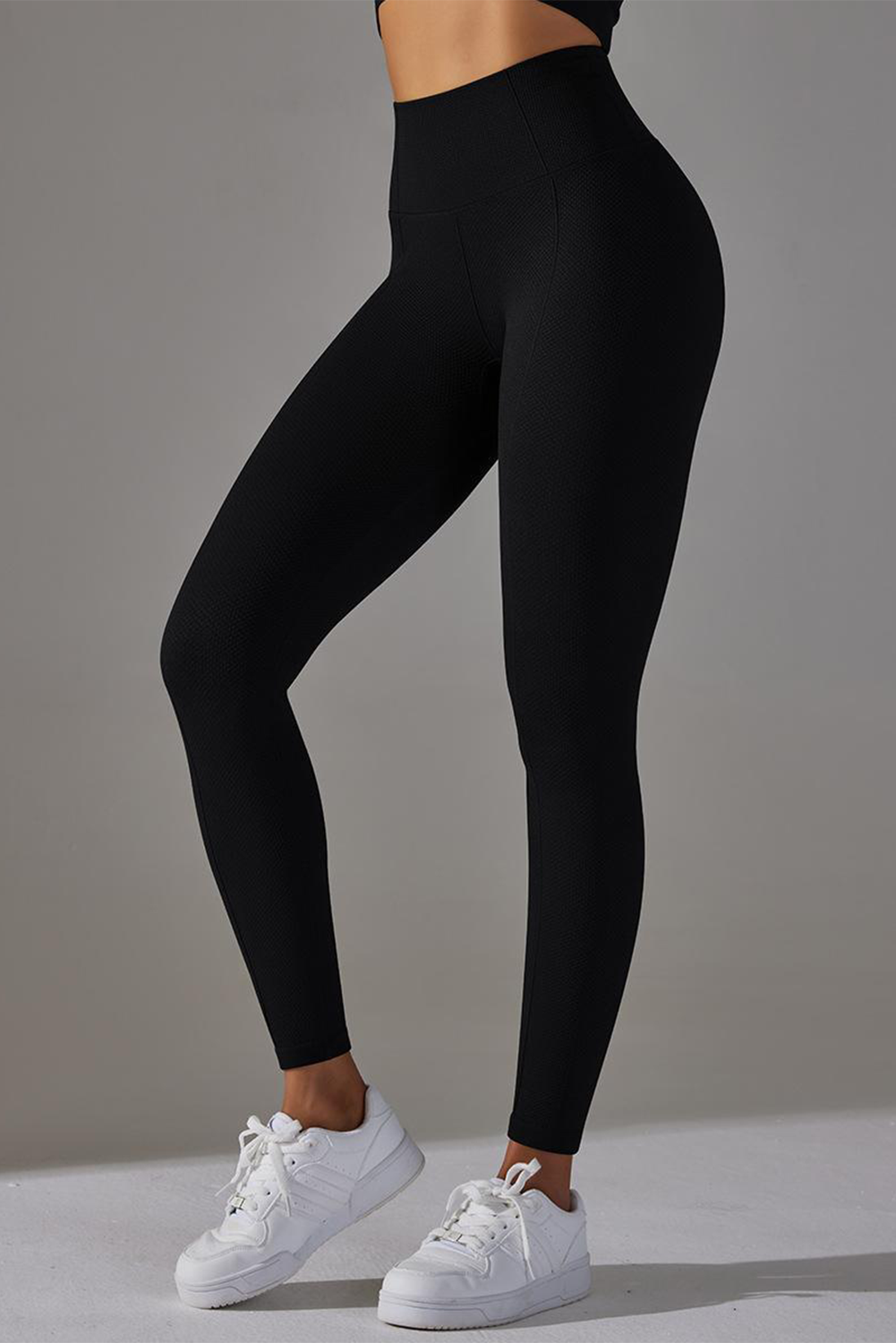 Dark grey high waist yoga leggings with stylish outer seam details, perfect for workouts and casual wear.