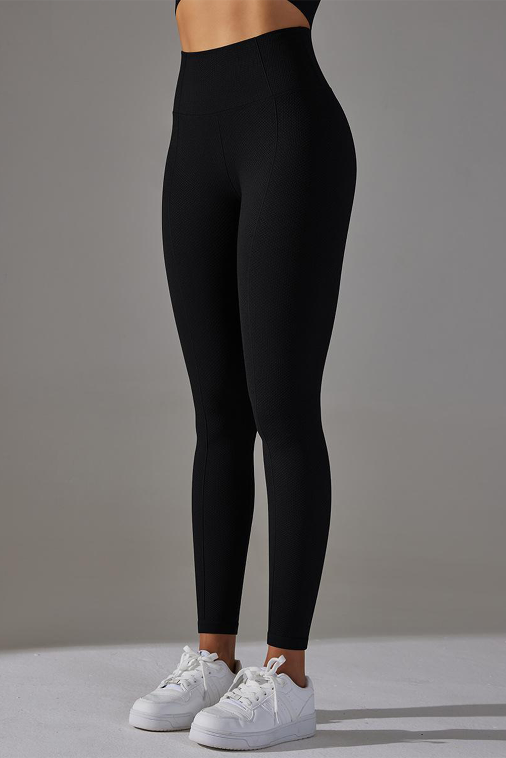 Dark grey high waist yoga leggings with stylish outer seam details, perfect for workouts and casual wear.