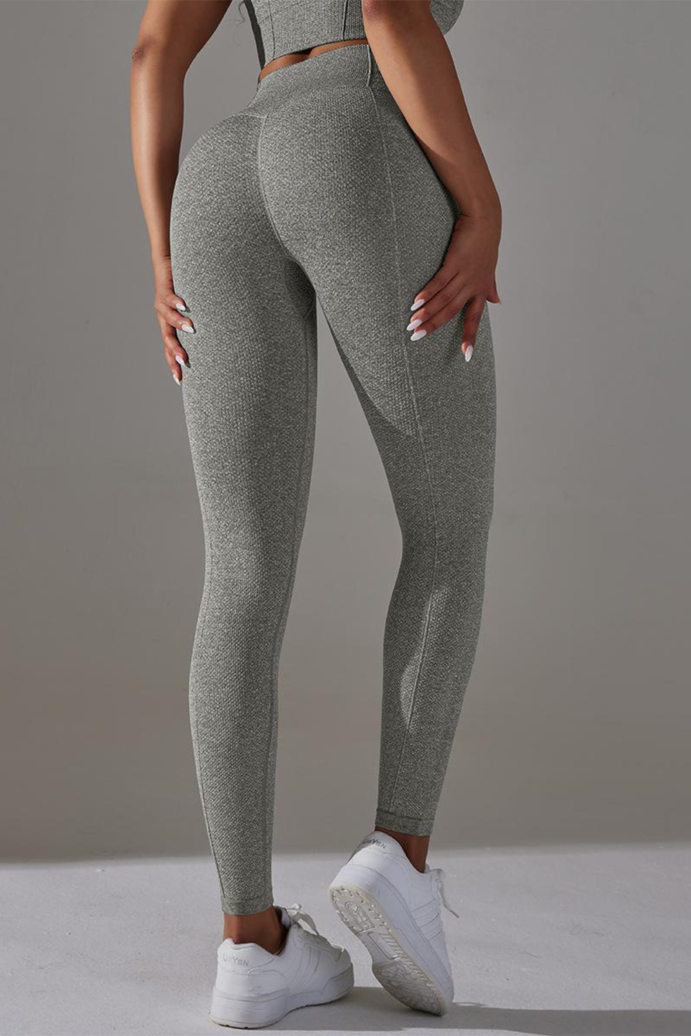 Dark grey high waist yoga leggings with stylish outer seam details, perfect for workouts and casual wear.