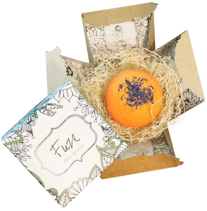 Energy - Bomb Core bath product featuring vibrant colors and essential oils, with a goat milk soap ball inside.