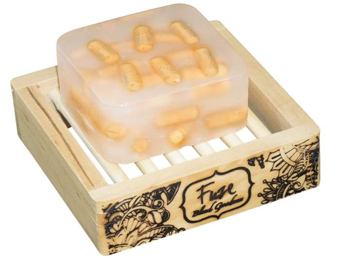 Energy Burst Bar with essential oils and fizzing action in a wooden soap dish.