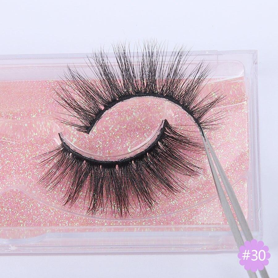 A pair of Faux 3D Mink Eyelashes displayed in a transparent box, showcasing their dramatic and wispy design.