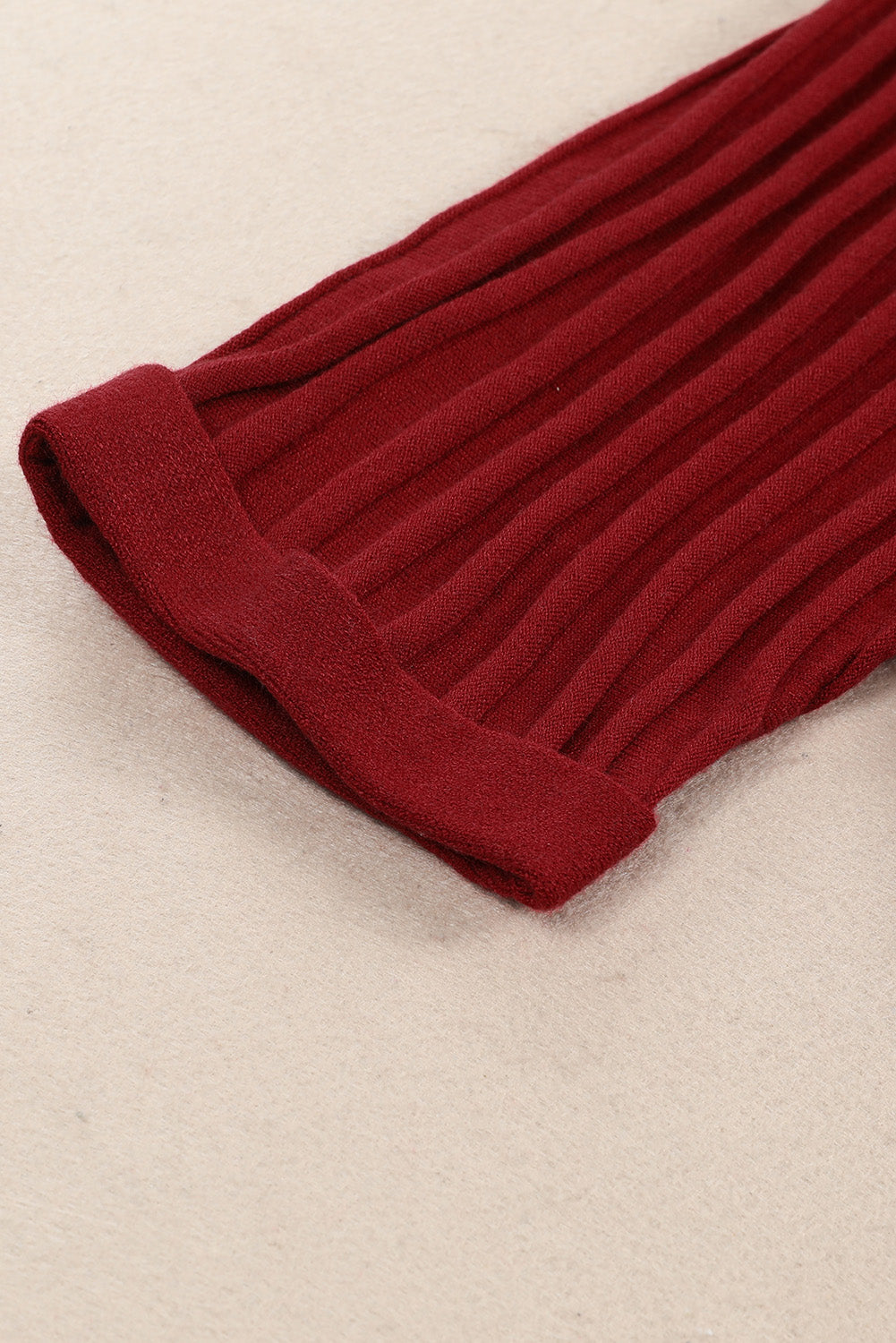 A stylish fiery red ribbed open front knit cardigan with 3/4 sleeves, perfect for layering over casual outfits.