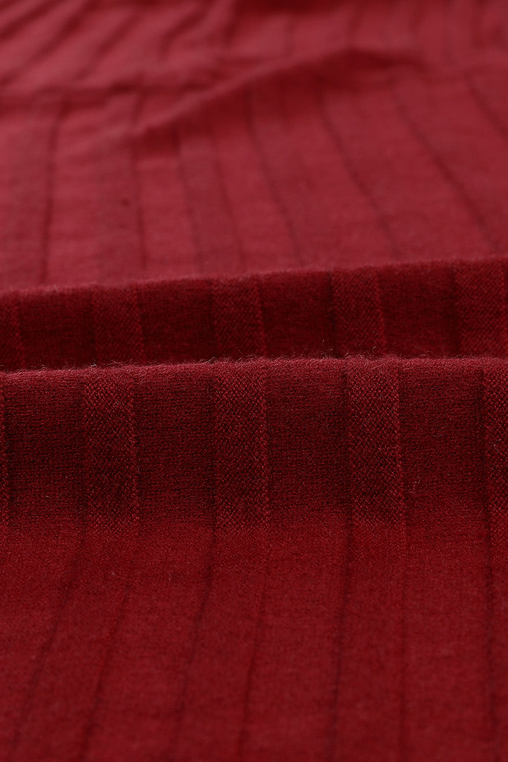 A stylish fiery red ribbed open front knit cardigan with 3/4 sleeves, perfect for layering over casual outfits.