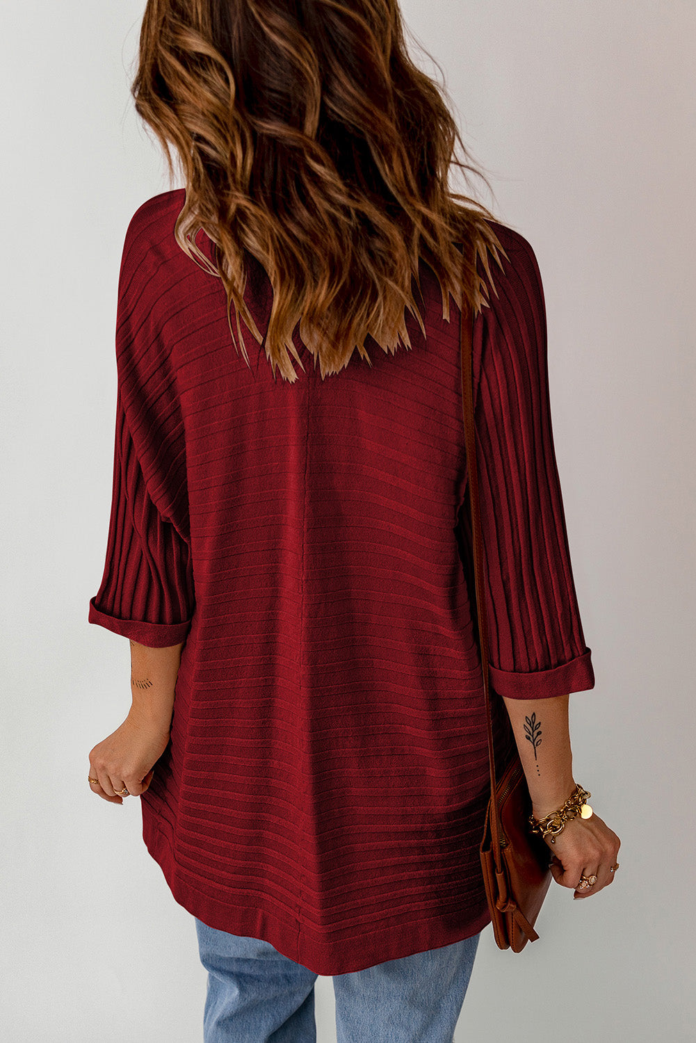 A stylish fiery red ribbed open front knit cardigan with 3/4 sleeves, perfect for layering over casual outfits.