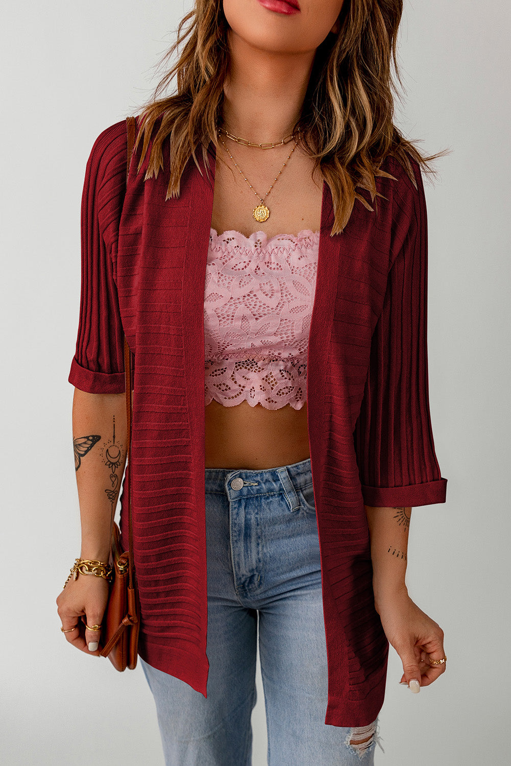 A stylish fiery red ribbed open front knit cardigan with 3/4 sleeves, perfect for layering over casual outfits.
