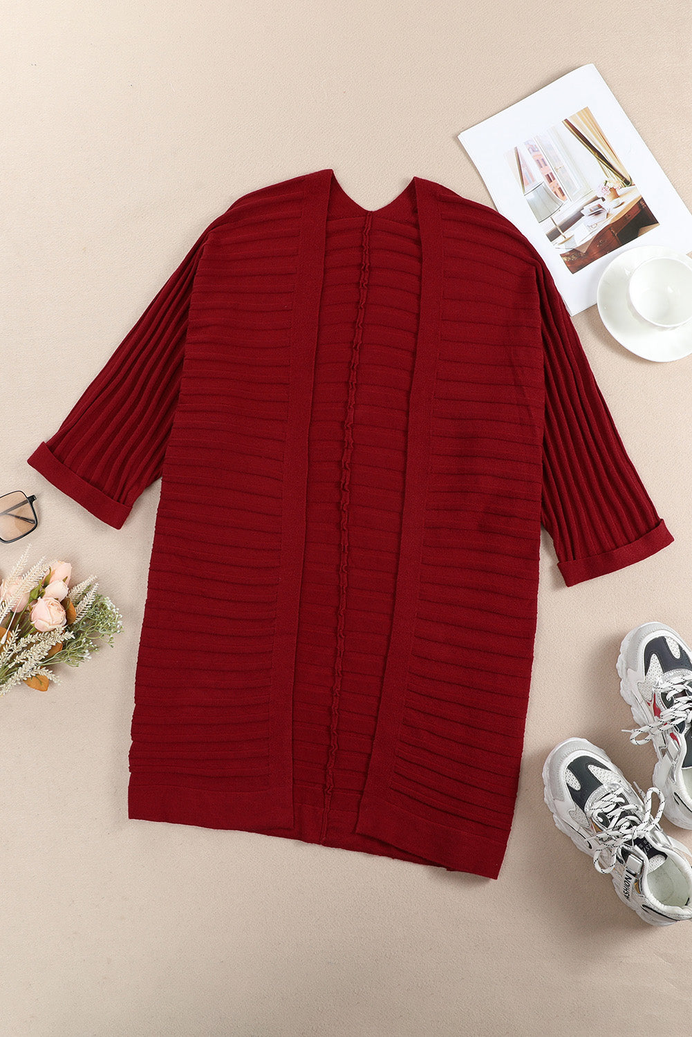 A stylish fiery red ribbed open front knit cardigan with 3/4 sleeves, perfect for layering over casual outfits.