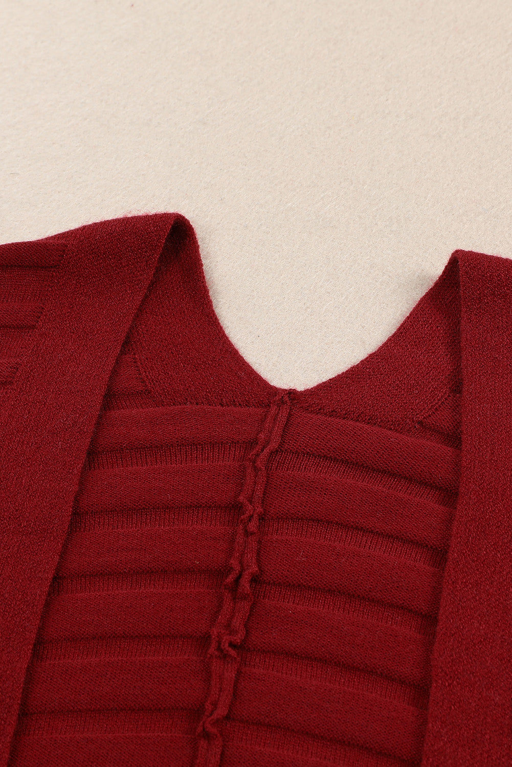 A stylish fiery red ribbed open front knit cardigan with 3/4 sleeves, perfect for layering over casual outfits.